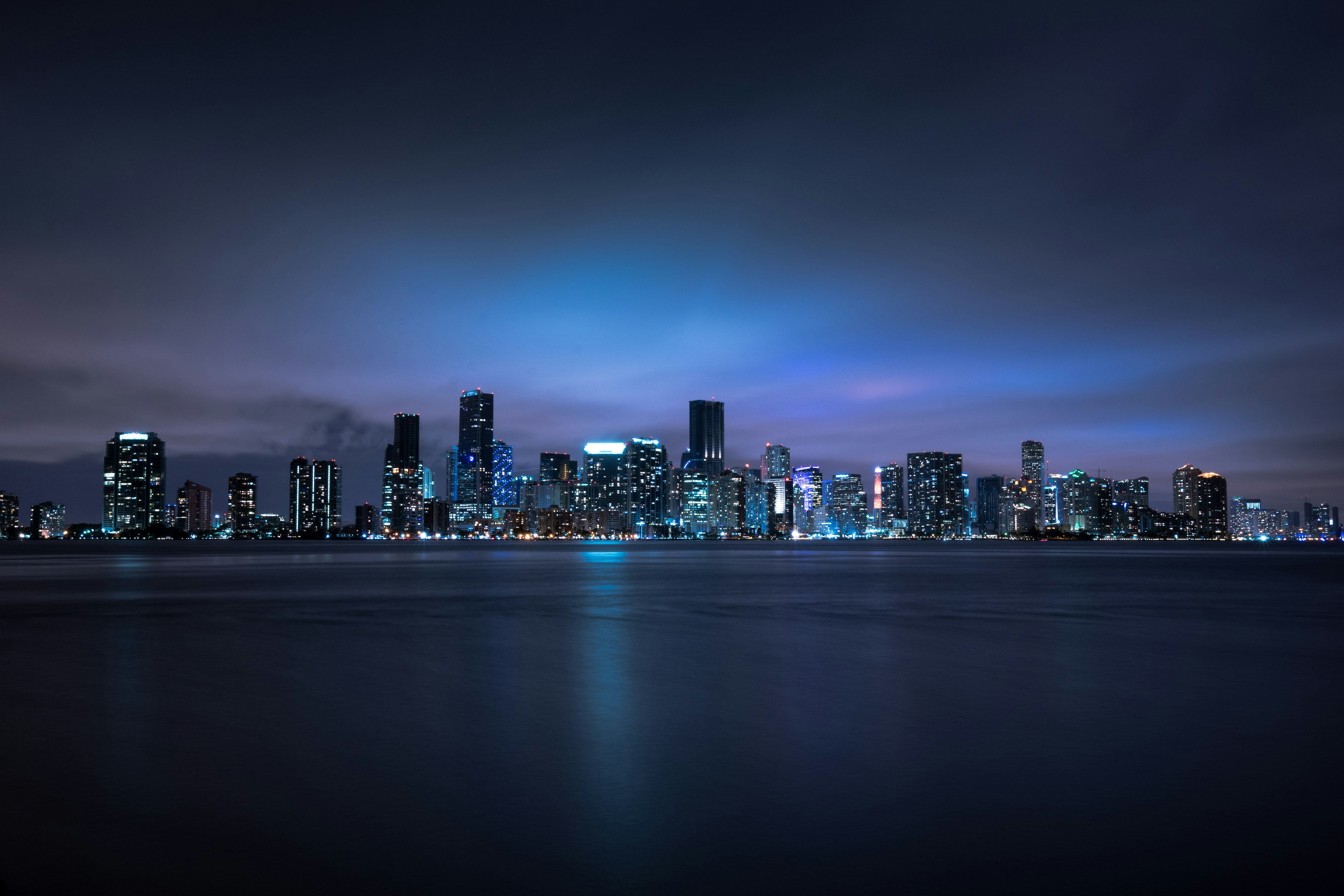 Downtown Miami skyline lit at night across the water
