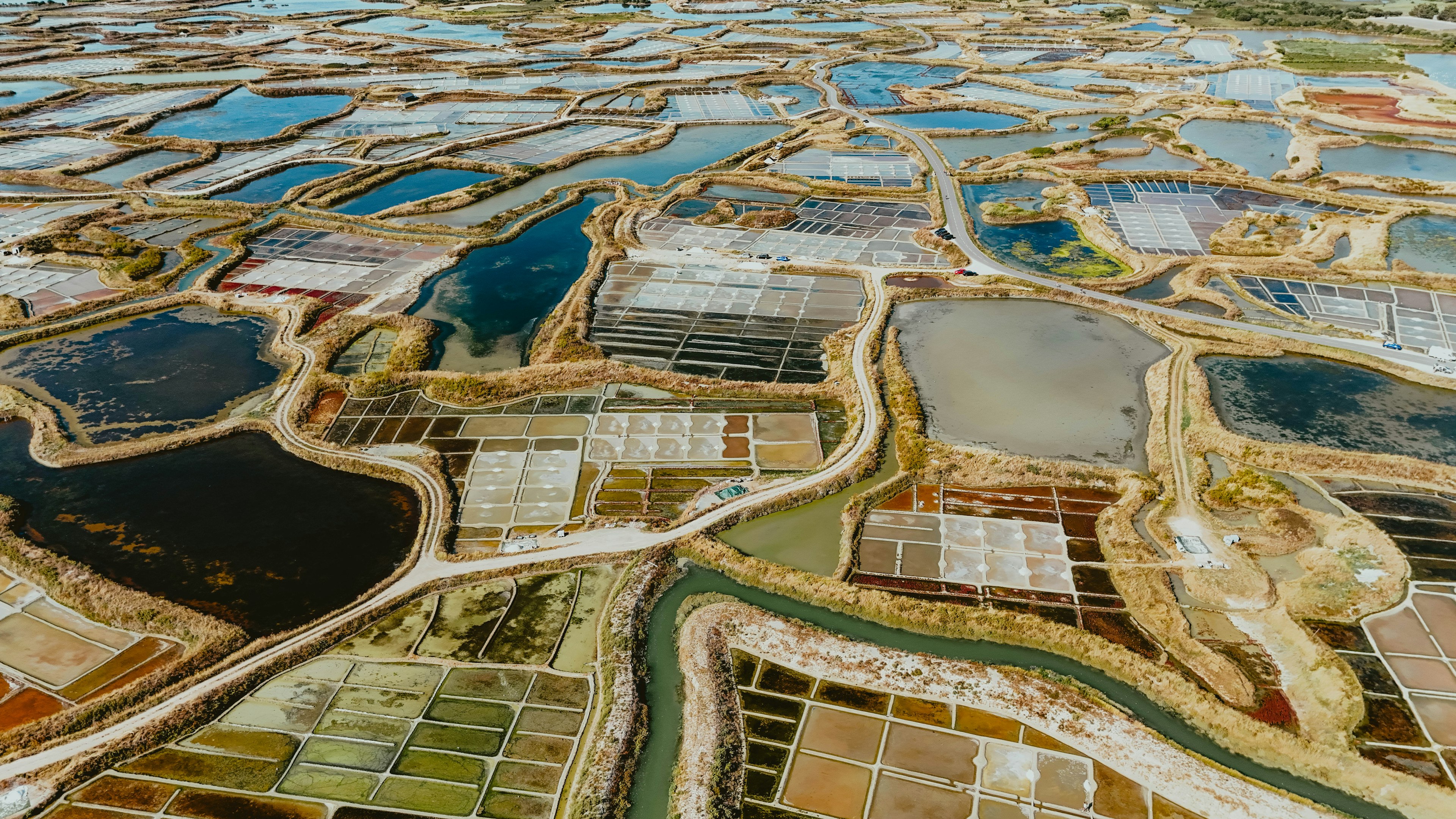Aerial view of colorful coastal salt-evaporation ponds